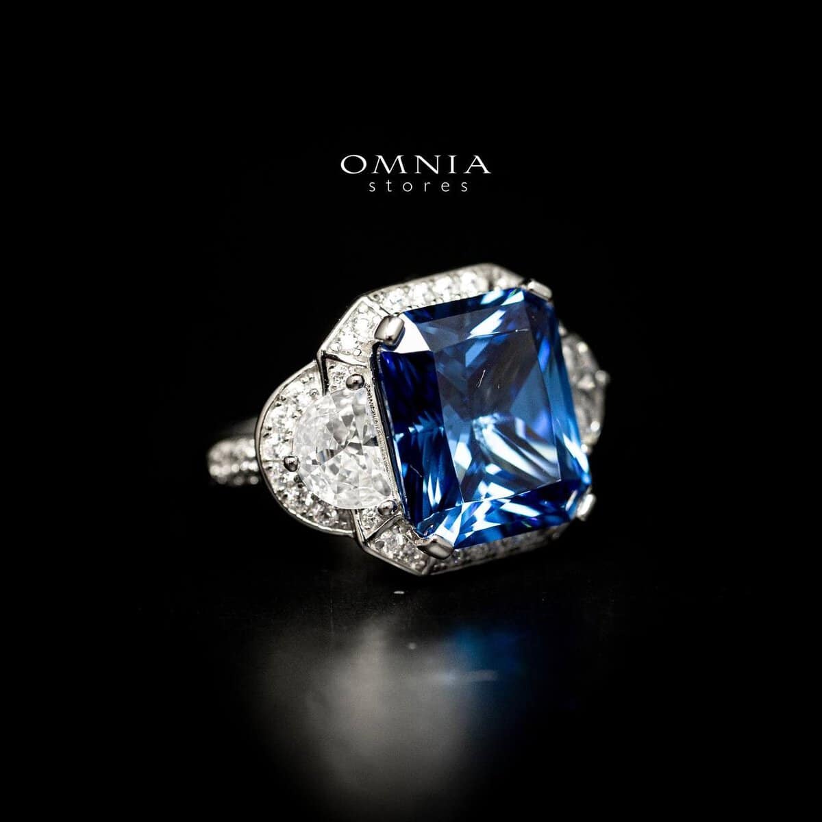 Omnia Sadeen Emerald Cut Sapphire Blue Ring in 92.5 Silver with High Quality Simulated Diamonds - OMNIASTORES UAE