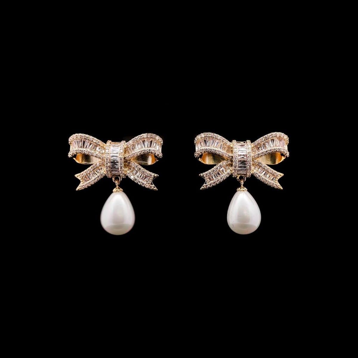 Omnia Imaan Golden Bow Drop Earrings with Pearl and High-Quality Zircon Stones in Rhodium-Plated Finish - OMNIASTORES UAE