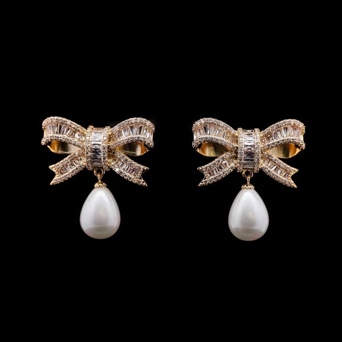 Omnia Imaan Golden Bow Drop Earrings with Pearl and High-Quality Zircon Stones in Rhodium-Plated Finish - OMNIASTORES UAE